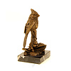 A bronze sculpture of a cardinal bird