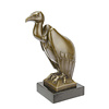 A bronze sculpture of a vulture