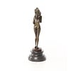 An erotic bronze sculpture of a standing female nude