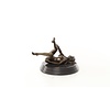 An erotic bronze sculpture of a reclining female nude