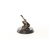 An erotic bronze sculpture of a reclining female nude