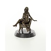 An erotic bronze sculpture of a seated female nude