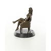 An erotic bronze sculpture of a seated female nude