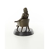 An erotic bronze sculpture of a seated female nude