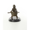 An erotic bronze sculpture of a seated female nude