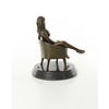 An erotic bronze sculpture of a seated female nude