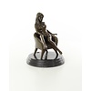 An erotic bronze sculpture of a seated female nude