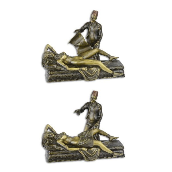  A Vienna bronze style sculpture of a nude female reclining on a sofa