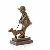 Bronze sculpture of a young girl walking her dog