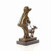 Bronze sculpture of a young girl walking her dog