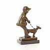 Bronze sculpture of a young girl walking her dog