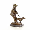 Bronze sculpture of a young girl walking her dog