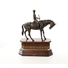 Bronzen sculptuur van jockey te paard op houten base