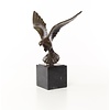 Bronze sculpture of a pigeon in flight