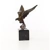 Bronze sculpture of a pigeon in flight