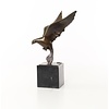 Bronze sculpture of a pigeon in flight