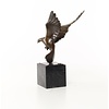 Bronze sculpture of a pigeon in flight