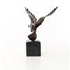 Bronze sculpture of a pigeon in flight
