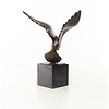 Bronze sculpture of a pigeon in flight