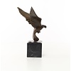 Bronze sculpture of a pigeon in flight