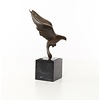 Bronze sculpture of a pigeon in flight