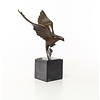 Bronze sculpture of a pigeon in flight