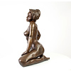 Large bronze sculpture of a kneeling female nude