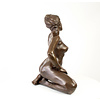 Large bronze sculpture of a kneeling female nude