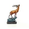 A bronze sculpture of a roaring stag on a rock