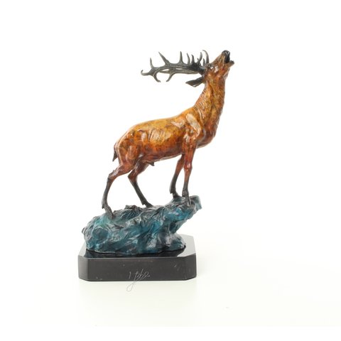 Roaring stag on a rock