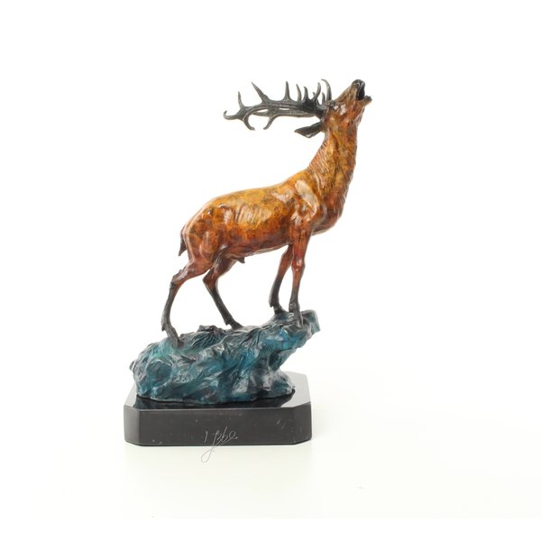  A bronze sculpture of a roaring stag on a rock