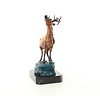 A bronze sculpture of a roaring stag on a rock