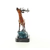 A bronze sculpture of a roaring stag on a rock