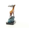 A bronze sculpture of a roaring stag on a rock