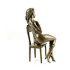 A bronze sculpture of an enticing female seated on a chair
