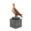 Bronze sculpture of a standing pigeon