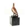 Bronze sculpture of a standing pigeon