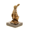 Bronze sculpture of a rabbit holding a carrot