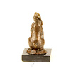 Bronze sculpture of a rabbit holding a carrot