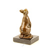 Bronze sculpture of a rabbit holding a carrot