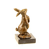 Bronze sculpture of a rabbit holding a carrot