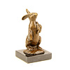 Bronze sculpture of a rabbit holding a carrot