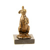 Bronze sculpture of a rabbit holding a carrot