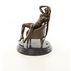 An erotic bronze sculpture of a sitting nude female