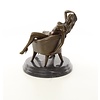An erotic bronze sculpture of a sitting nude female