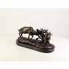 Bronze sculpture of two fighting stags