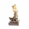 Bronze sculpture of a cardinal bird sitting on a branch