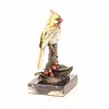 Bronze sculpture of a cardinal bird sitting on a branch