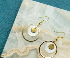 Round gold earrings with shell