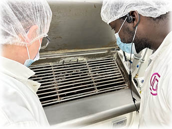Two people inspecting the progress of chocolate production